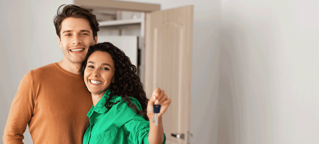 Image: Happy, Young Couple Enter Their New Home